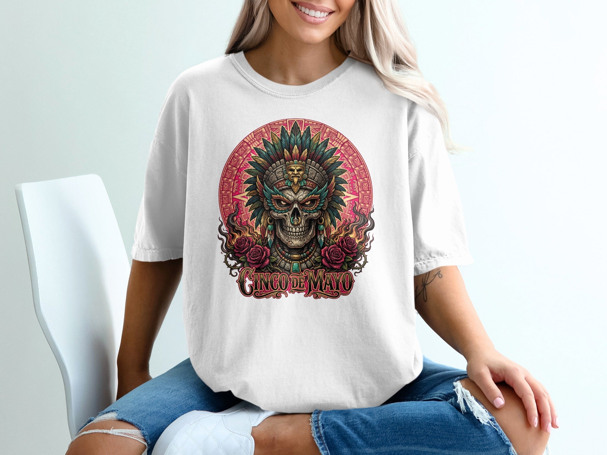 White t-shirt with a vibrant Dia de Muertos skull design, featuring roses and "Cinco de Mayo" text.