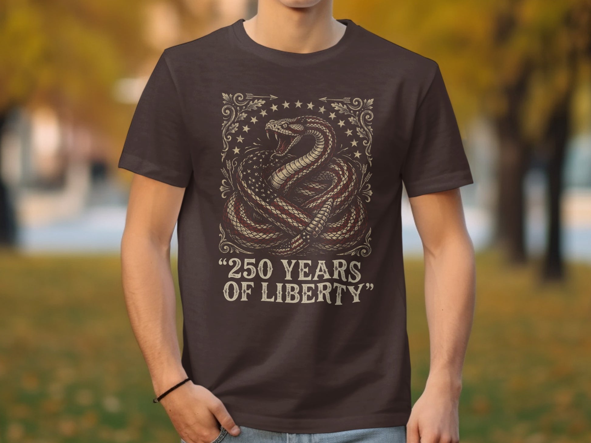 Brown t-shirt with coiled snake design featuring American flag and "250 YEARS OF LIBERTY".