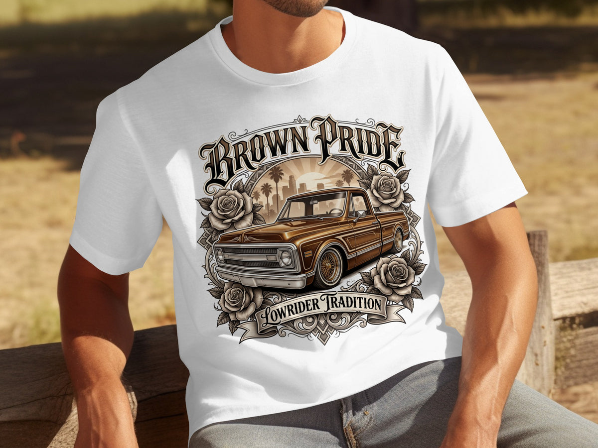 White t-shirt with brown "BROWN PRIDE" text, a lowrider truck, roses, and "LOWRIDER TRADITION" text.