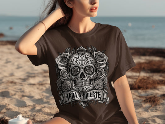 Brown t-shirt with a detailed sugar skull and roses design, reading "VIDA Y MUERTE".