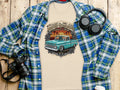 T-shirt with a graphic of a teal lowrider truck and text 