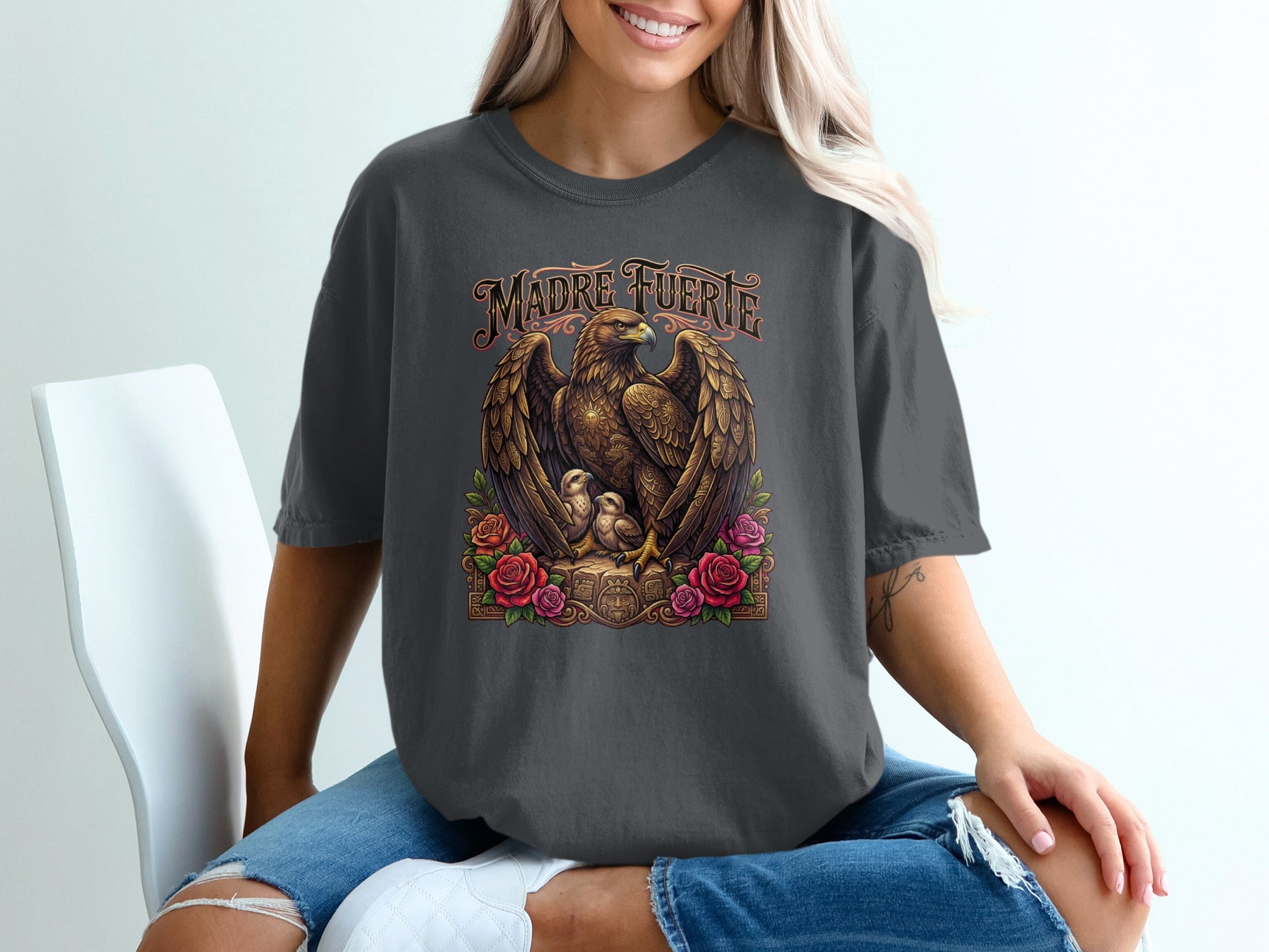 Dark gray t-shirt with an eagle and chicks design and the words "Madre Fuerte".