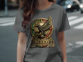 Dark grey t-shirt with circular Mexican eagle emblem featuring gold, green, and red.