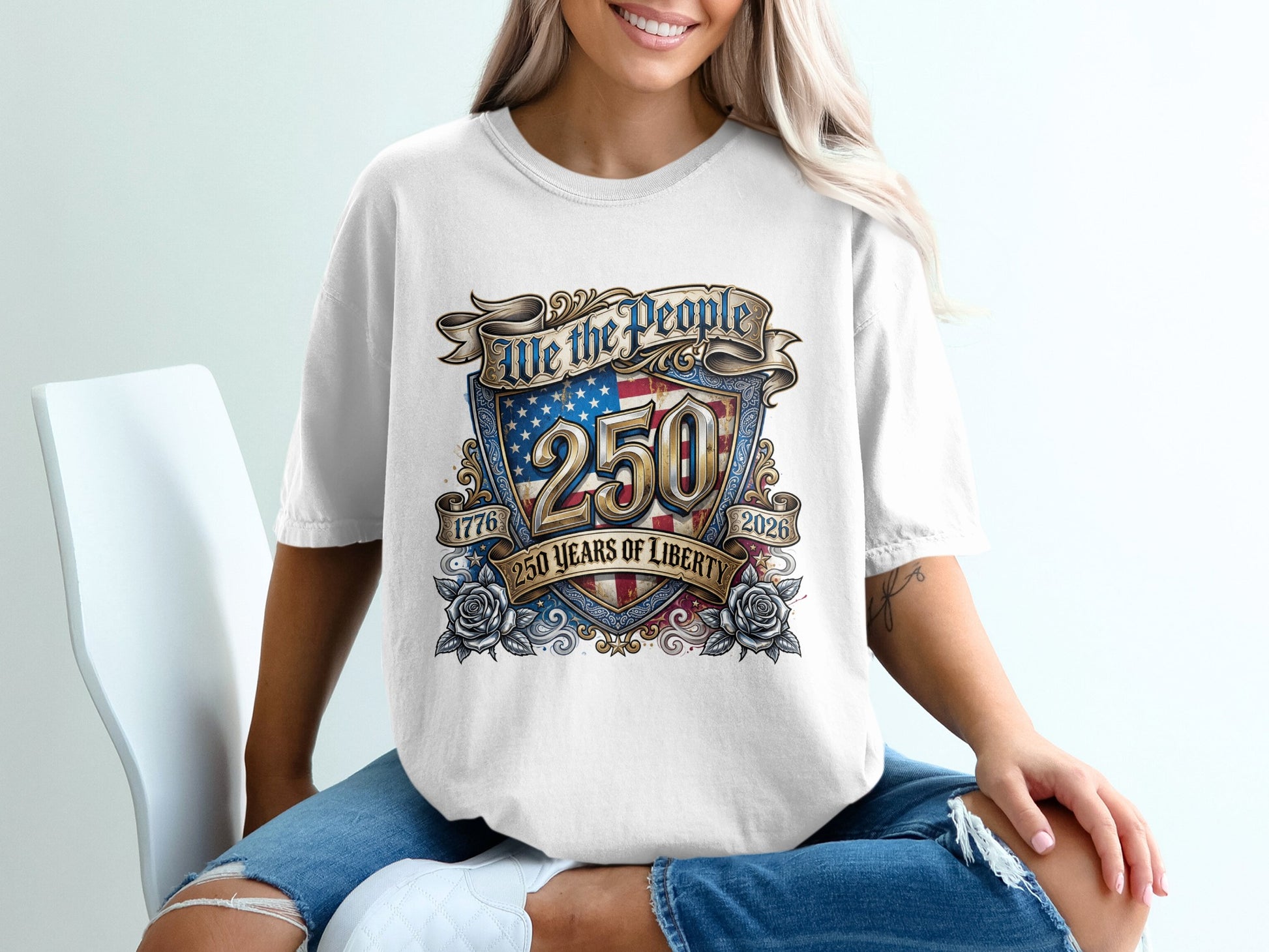 T-shirt with "We the People 250 Years of Liberty 1776-2026" text and American flag shield.