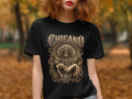 Black t-shirt with Chicano design of a warrior holding a woman.