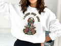 White sweatshirt with World Cup 2026 North America trophy and rose design.
