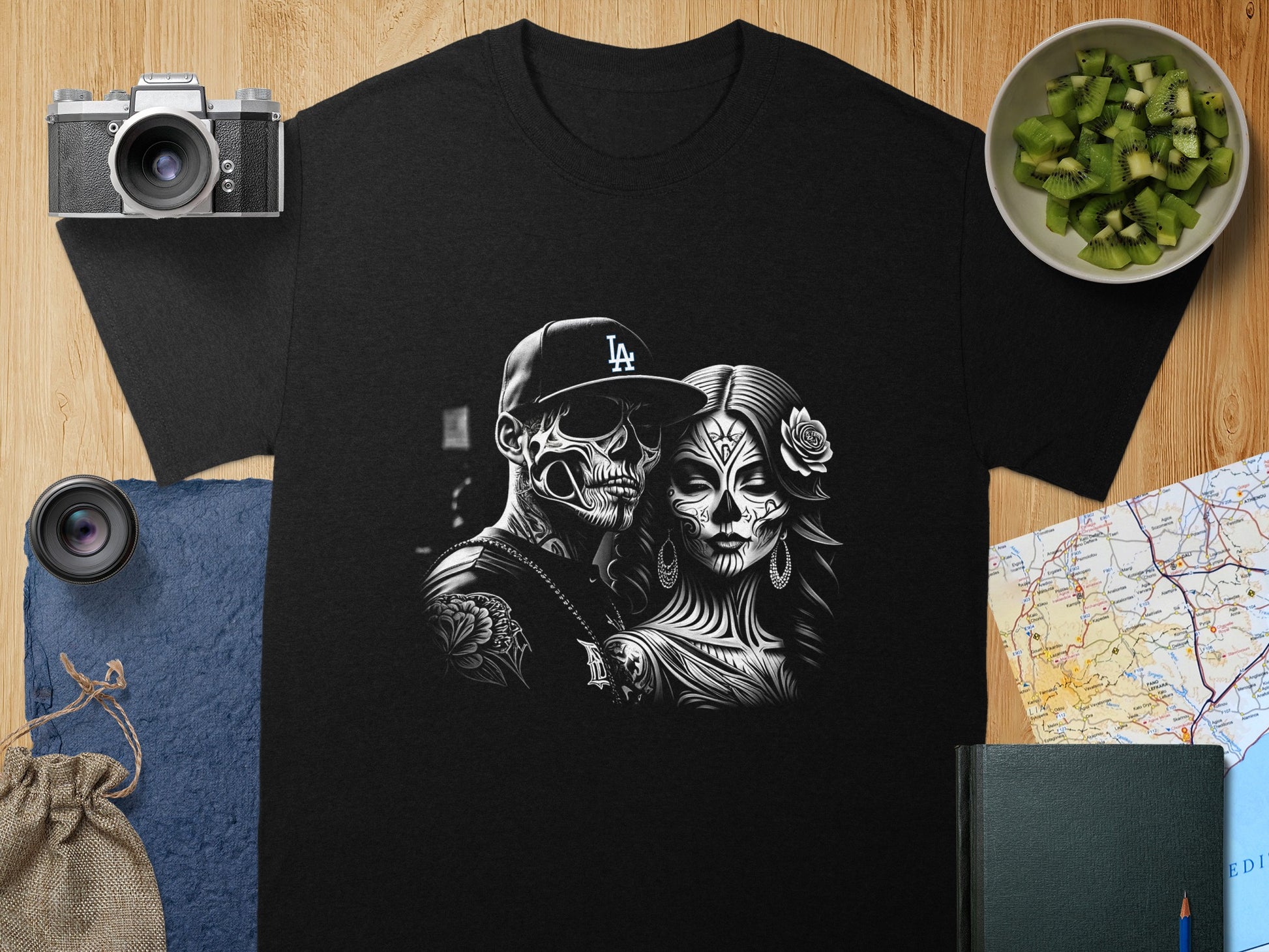 Black t-shirt featuring a black and white skull couple design with LA logo.