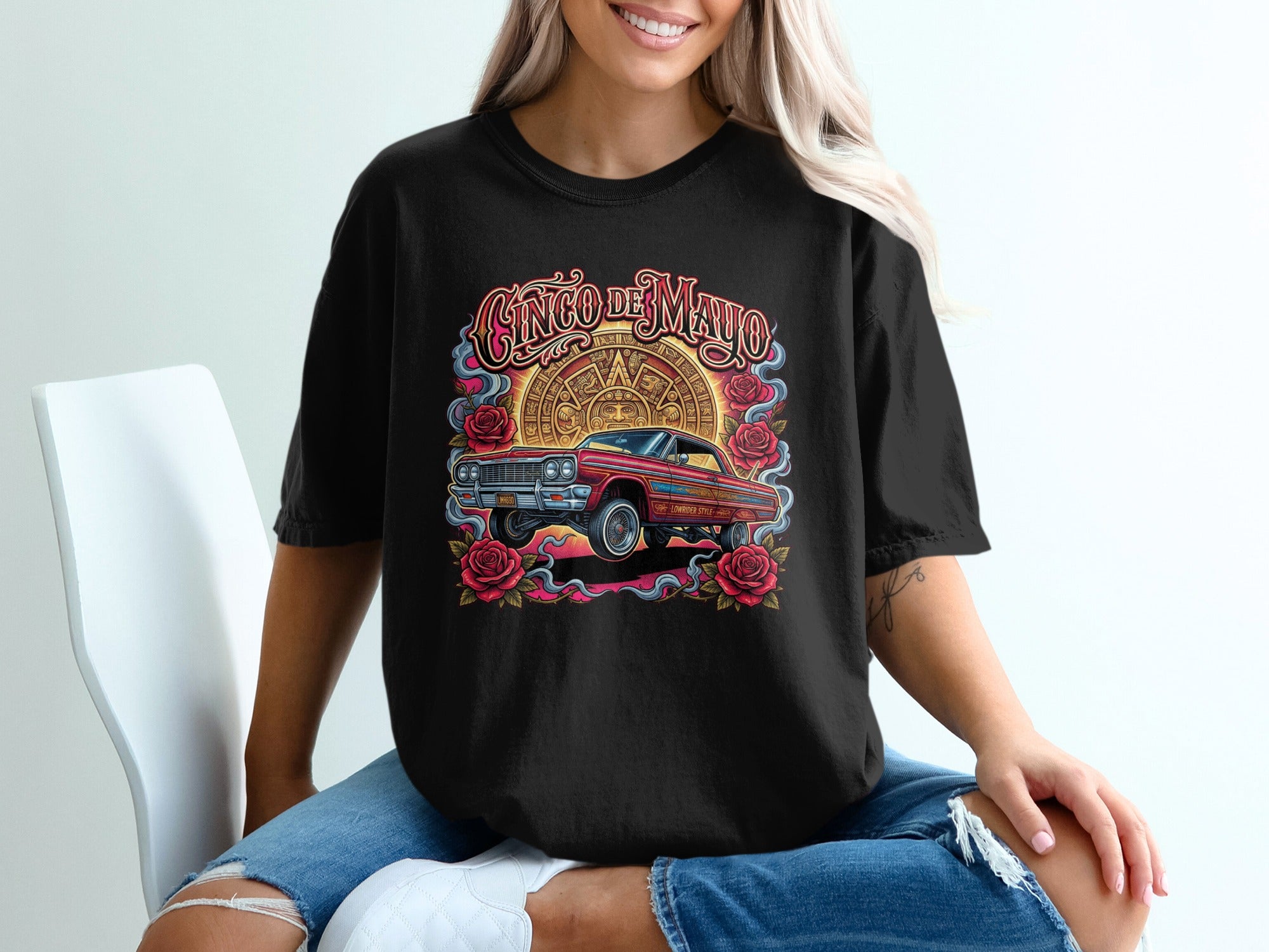 Black t-shirt with Cinco de Mayo design featuring a red lowrider and Mayan calendar.