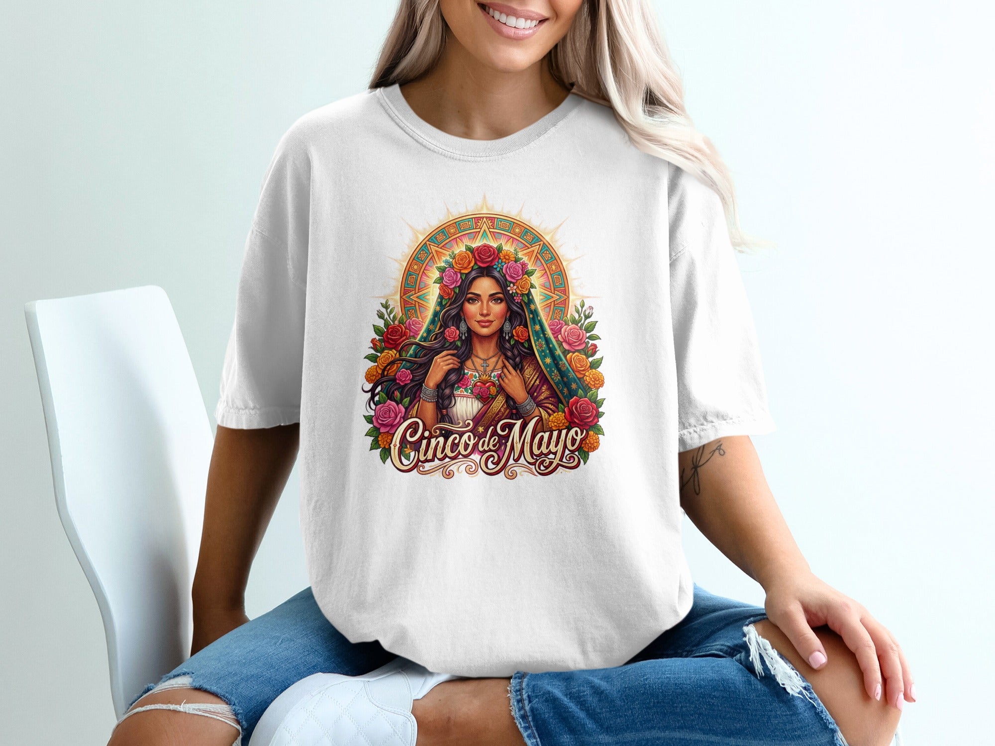 Woman wearing a white t-shirt with a colorful Cinco de Mayo graphic.
