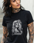 Black t-shirt featuring a Chicana skull with roses and a moonlit background.