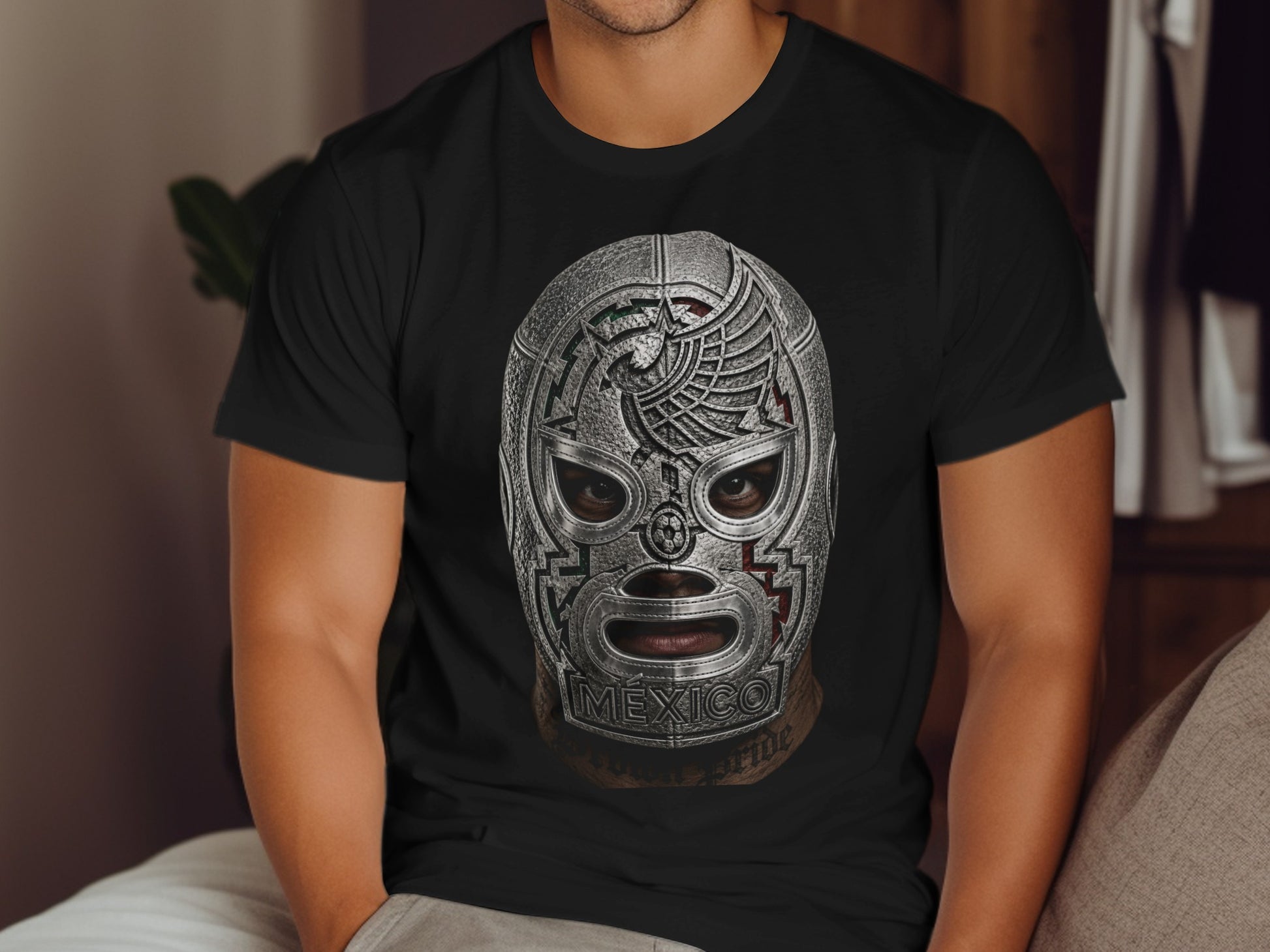 Man wearing a silver lucha libre mask with "MEXICO" text and eagle design.
