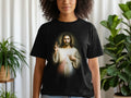Black t-shirt with Jesus Christ artwork, pointing upwards.