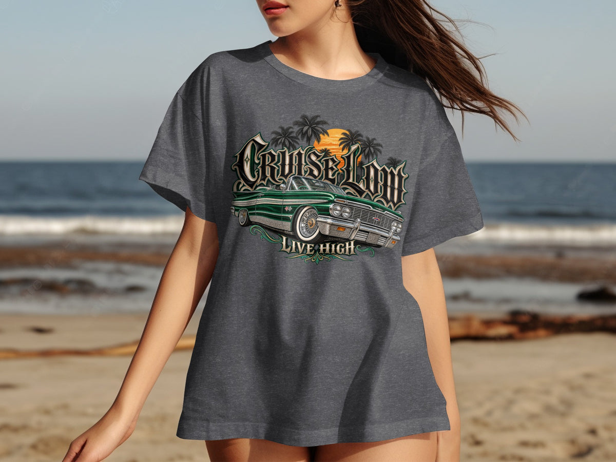 Dark gray t-shirt with graphic of green lowrider, palm trees, and sunset. Text says "CRUISE LOM LIVE HIGH".