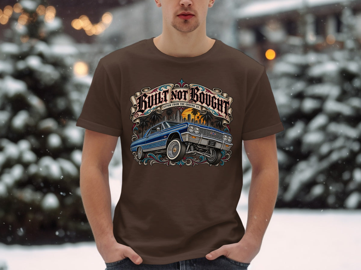 Brown t-shirt with a graphic of a blue 1963 Impala and "Built Not Bought" text.