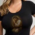 Black t-shirt featuring a painted image of Jesus Christ kneeling in prayer.