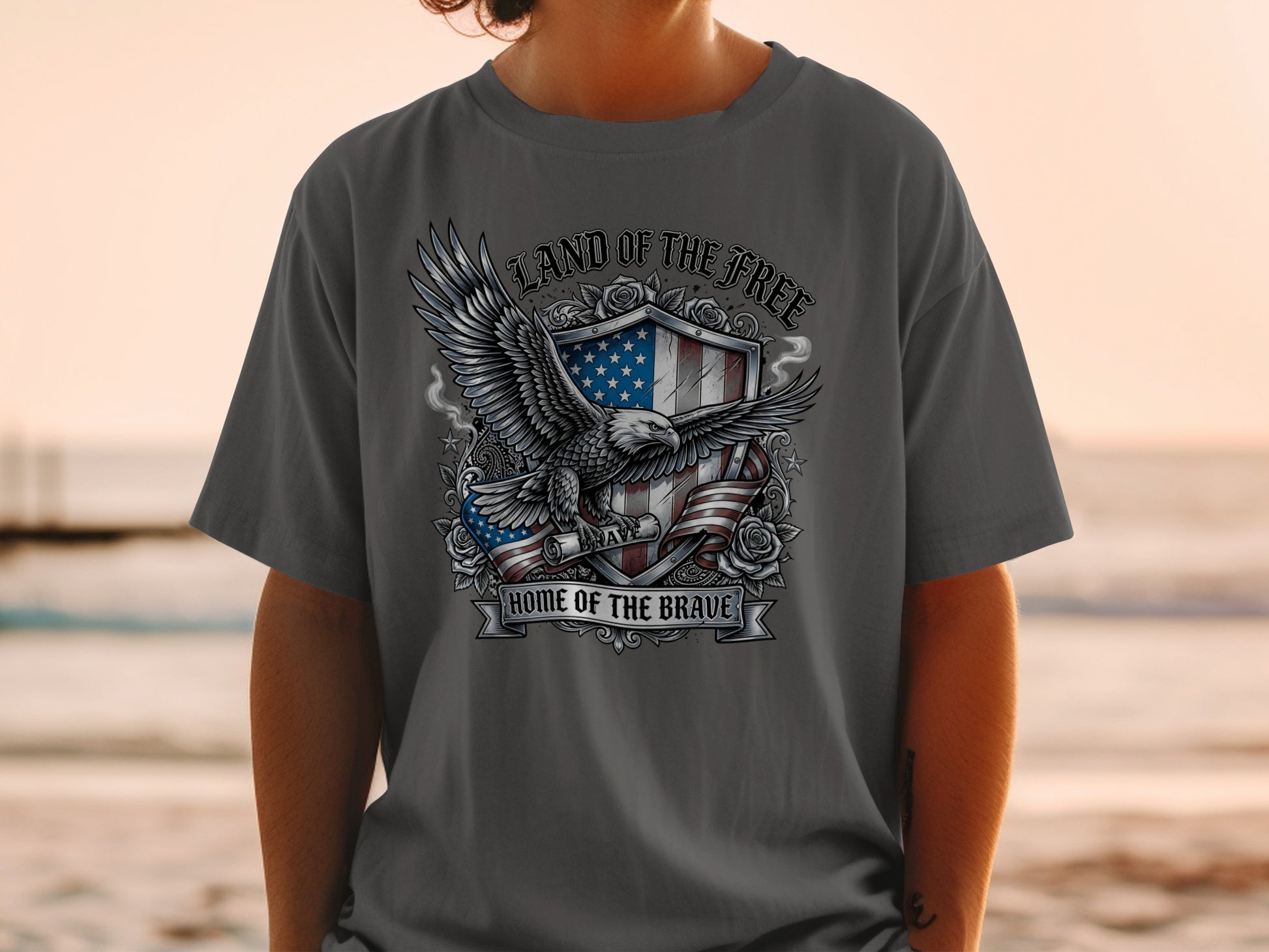 Shield with eagle, roses, and American flag, text "Land of the Free, Home of the Brave".