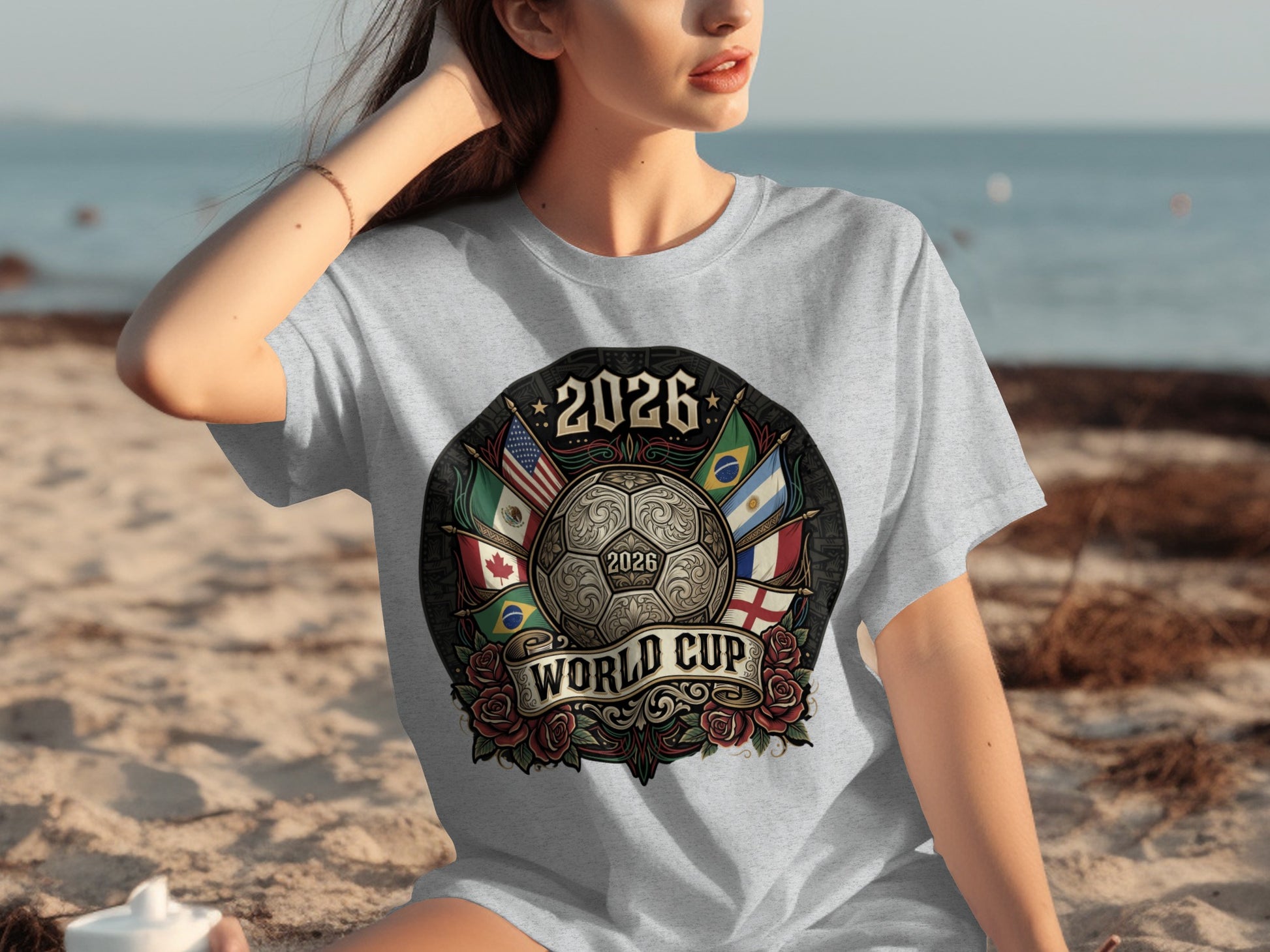 2026 World Cup emblem with flags, soccer ball, and roses on a grey t-shirt.