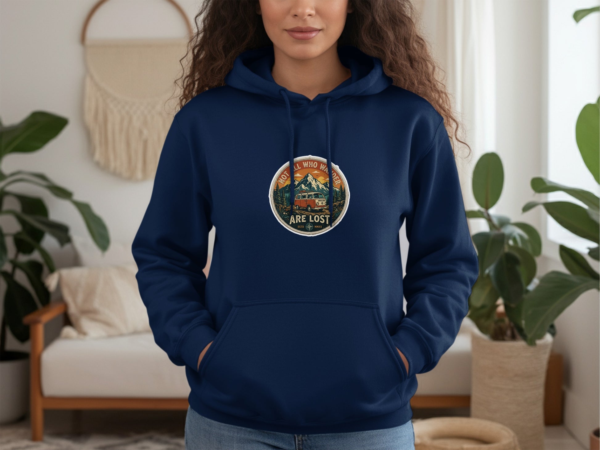Navy blue hoodie with circular graphic of a van and mountains, text "Not all who wander are lost."