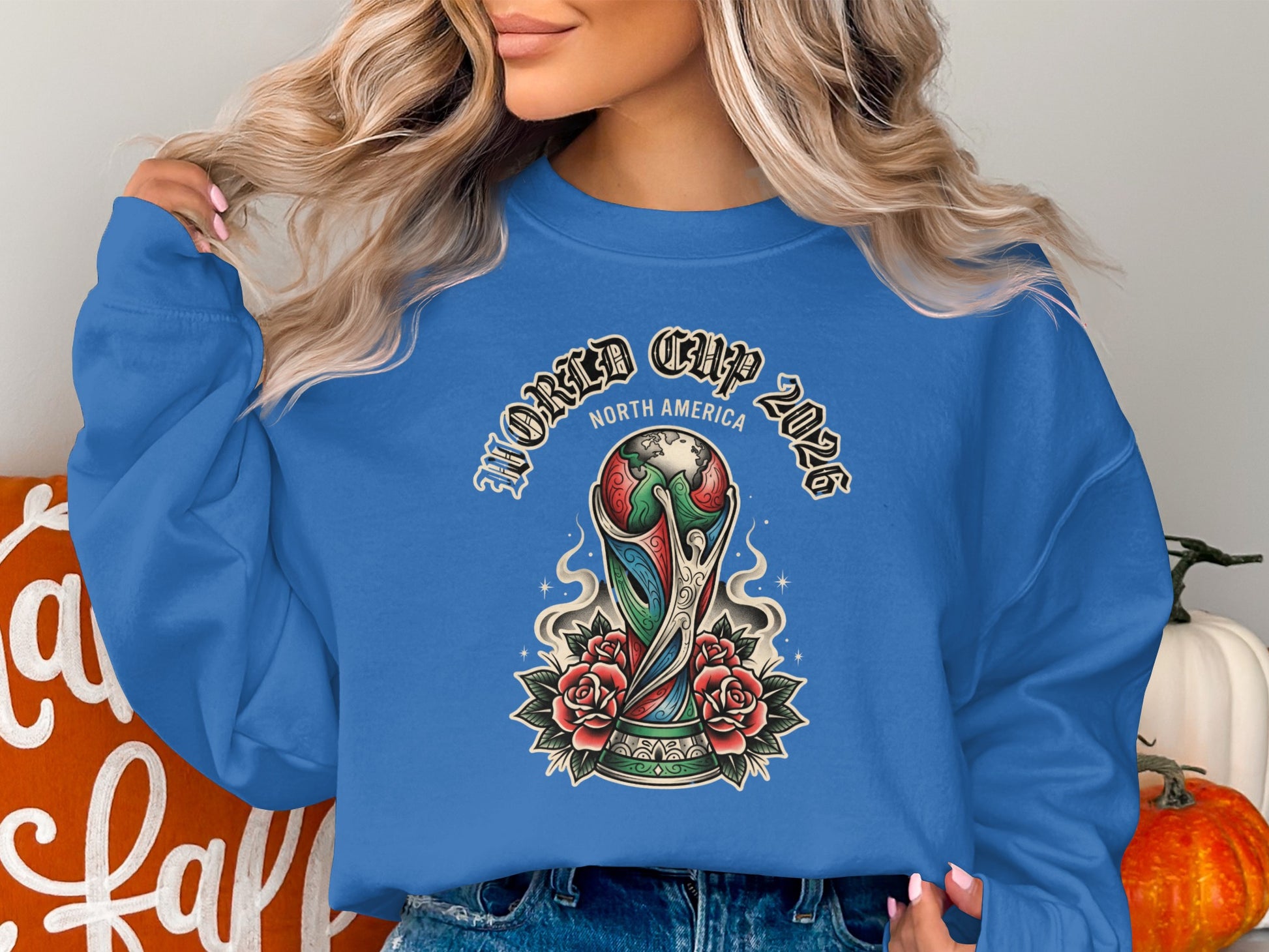 Blue sweatshirt with World Cup 2026 North America trophy graphic and roses.