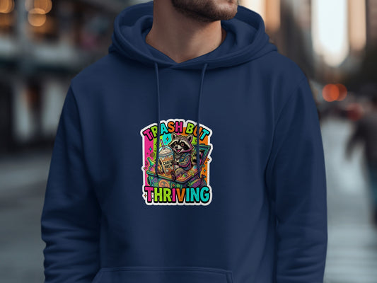 Navy hoodie with colorful trash panda graphic: "Trash but Thriving."