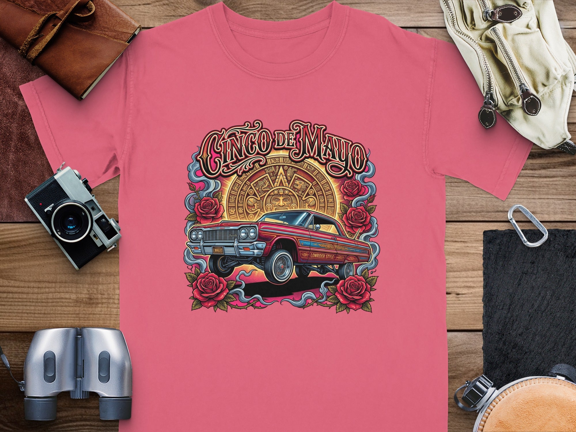 Lowrider car and roses graphic on pink t-shirt, "Cinco de Mayo" text.