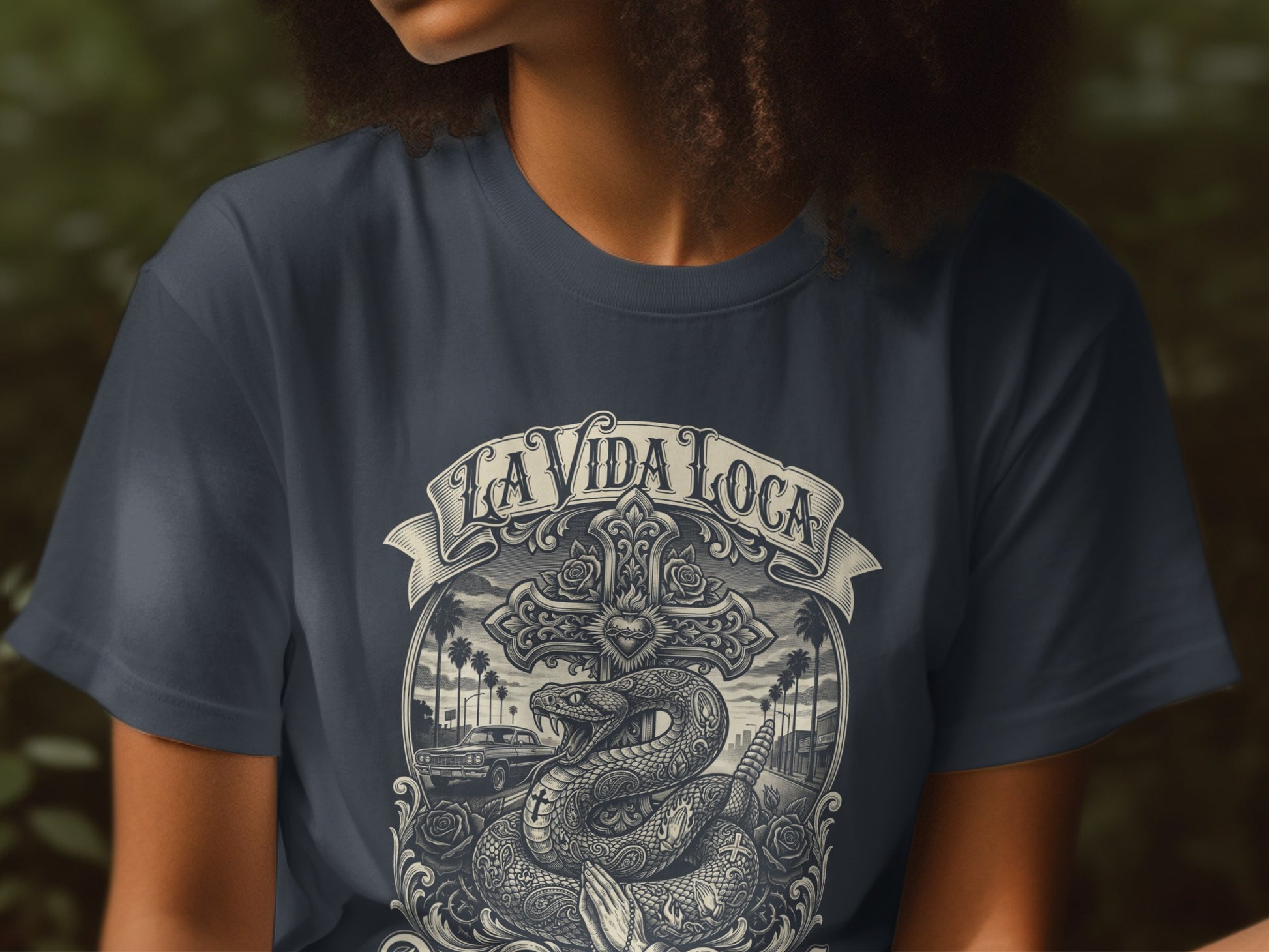 T-shirt with "La Vida Loca" text, snake, cross, and car design.