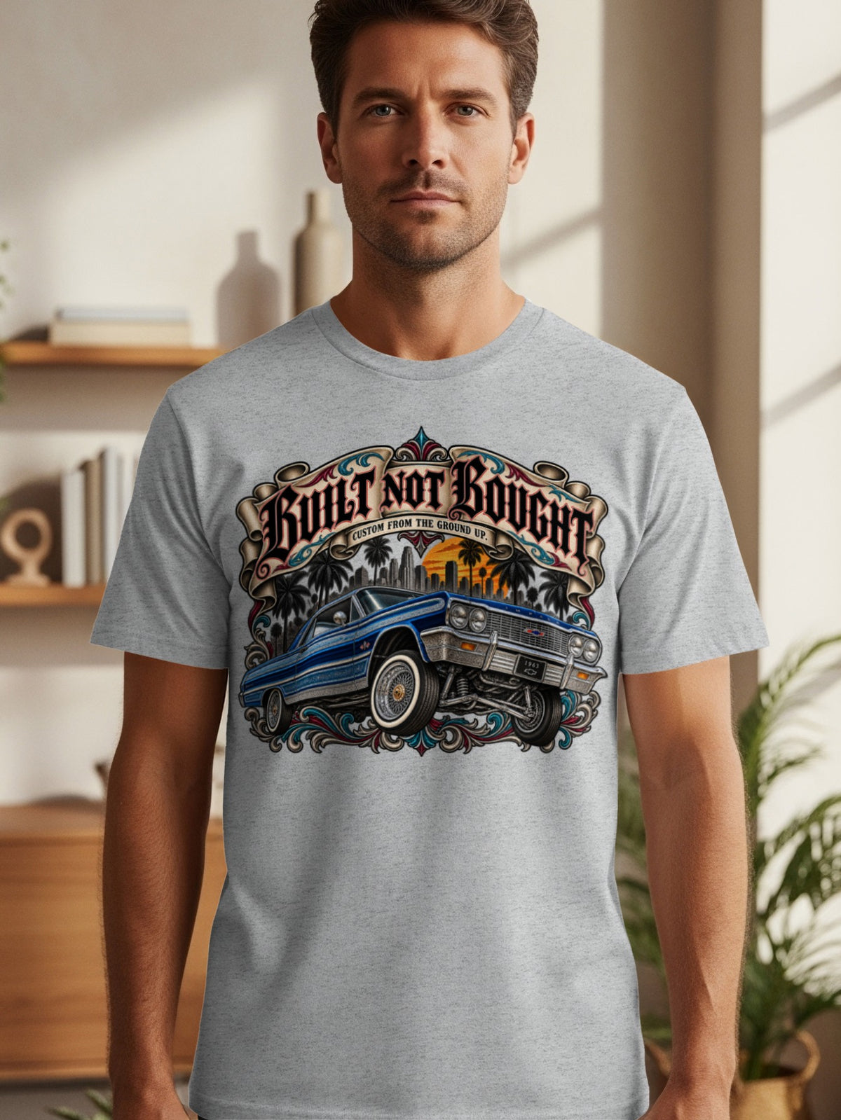 Grey t-shirt with a blue classic car and "Built Not Bought" text.