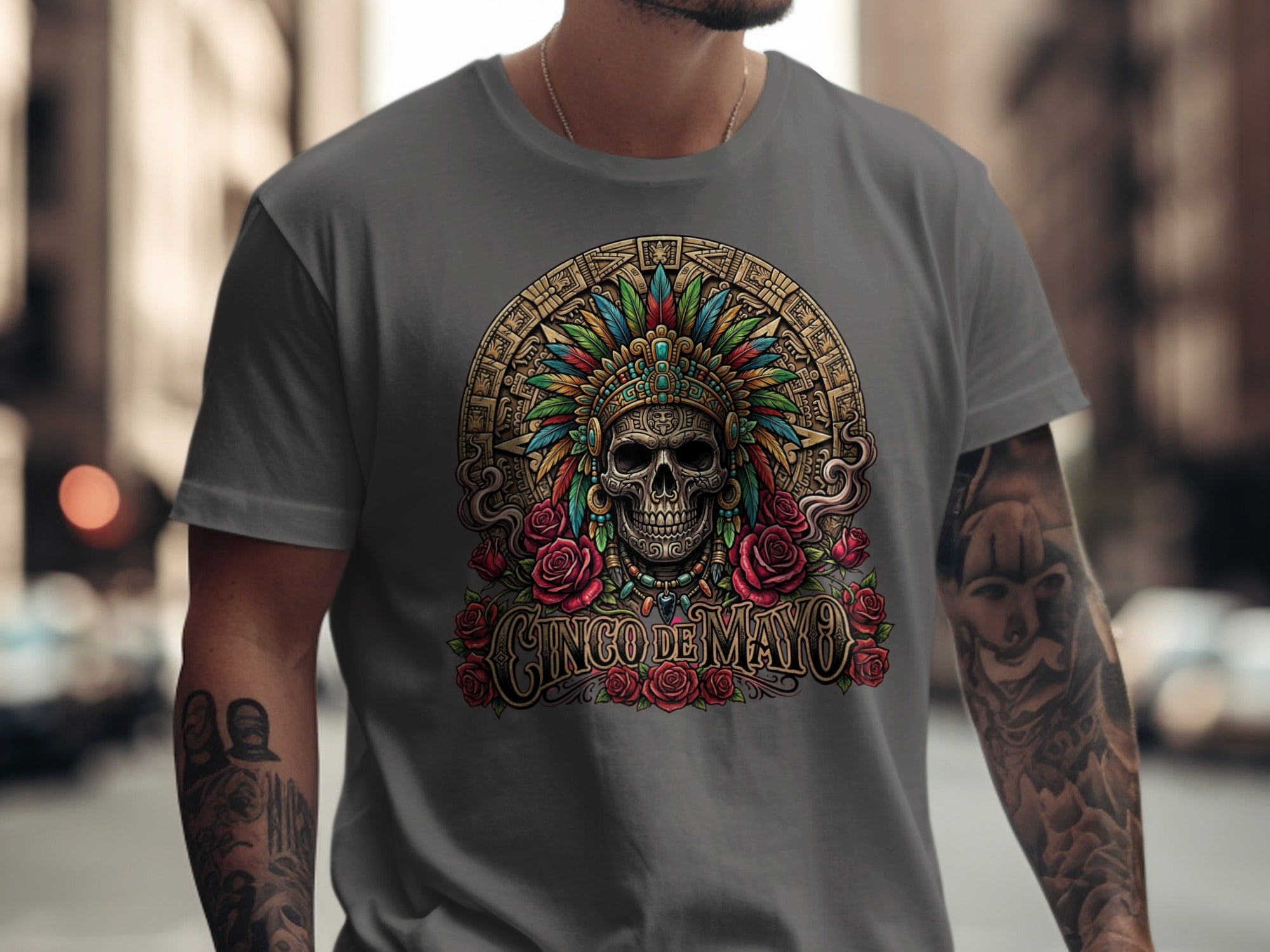 Skull with feathered headdress and roses, "Cinco de Mayo" text.