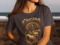 T-shirt graphic depicts a warrior holding a woman, with ornate feather headdress.