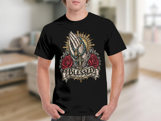 Black t-shirt with praying hands, roses, crucifix, and "BLESSED" text design.