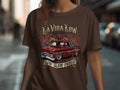 Brown t-shirt with a lowrider truck, flames, roses, and text 