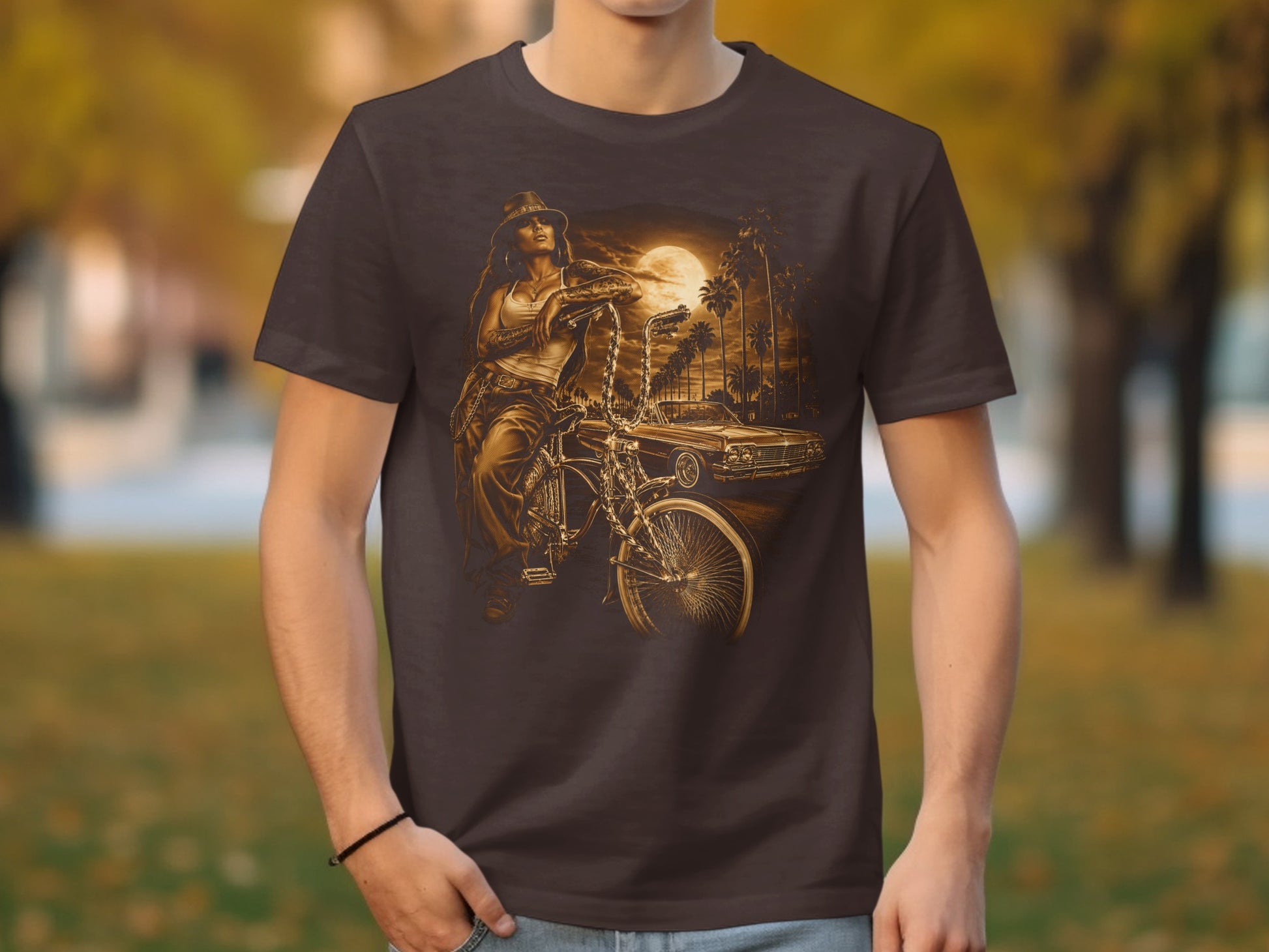 T-shirt with graphic of woman on bicycle next to classic car at sunset.