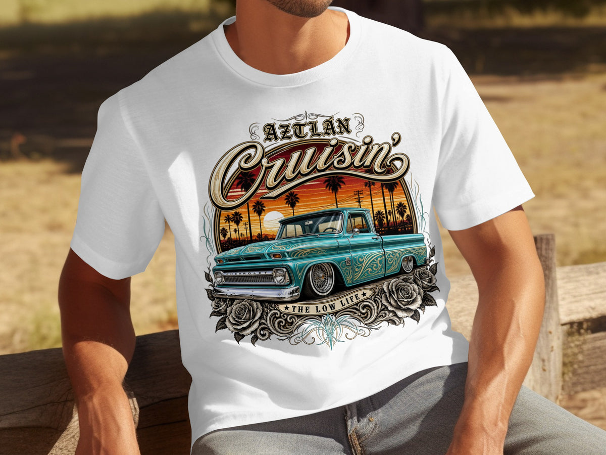 White t-shirt with graphic of teal lowrider truck, palm trees, sunset, roses, and text.