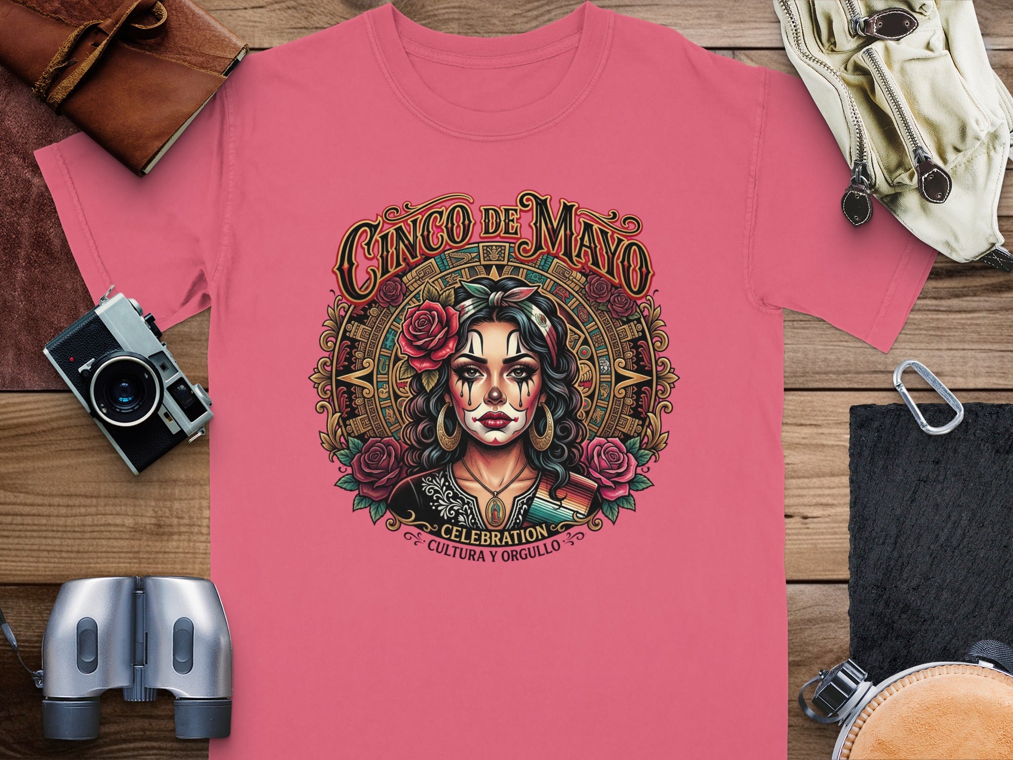 Cinco de Mayo graphic on pink t-shirt with skull, flowers, and decorative border.