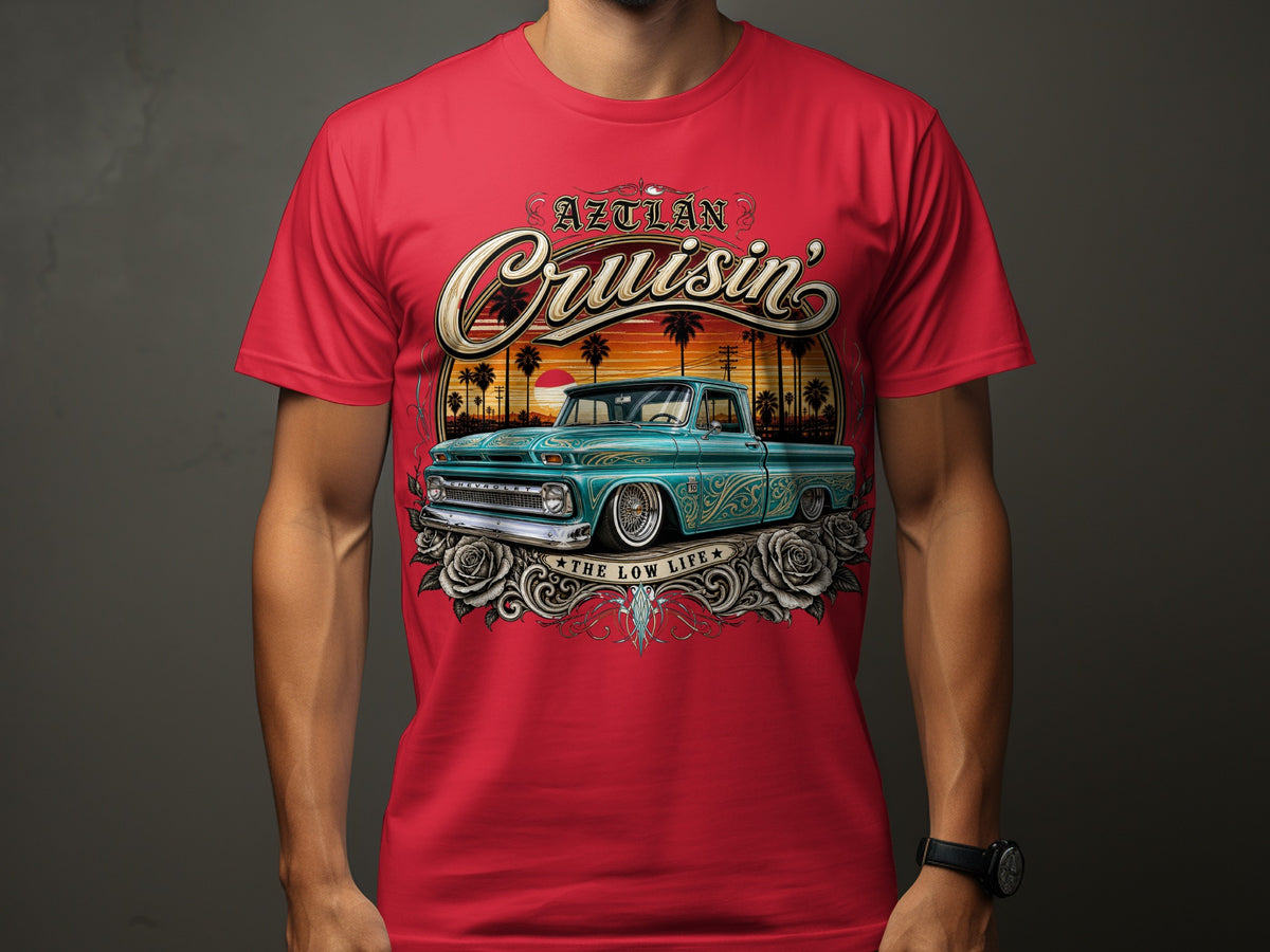 Red t-shirt with "Aztlán Cruisin'" text above a teal pickup truck.