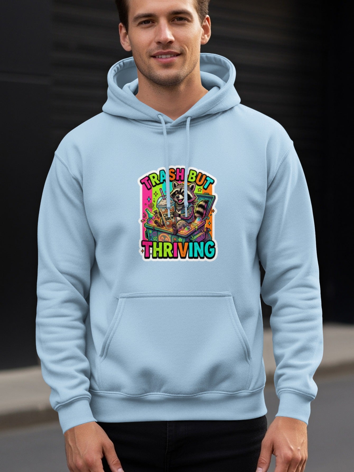 Light blue hoodie with "Trash But Thriving" raccoon graphic.