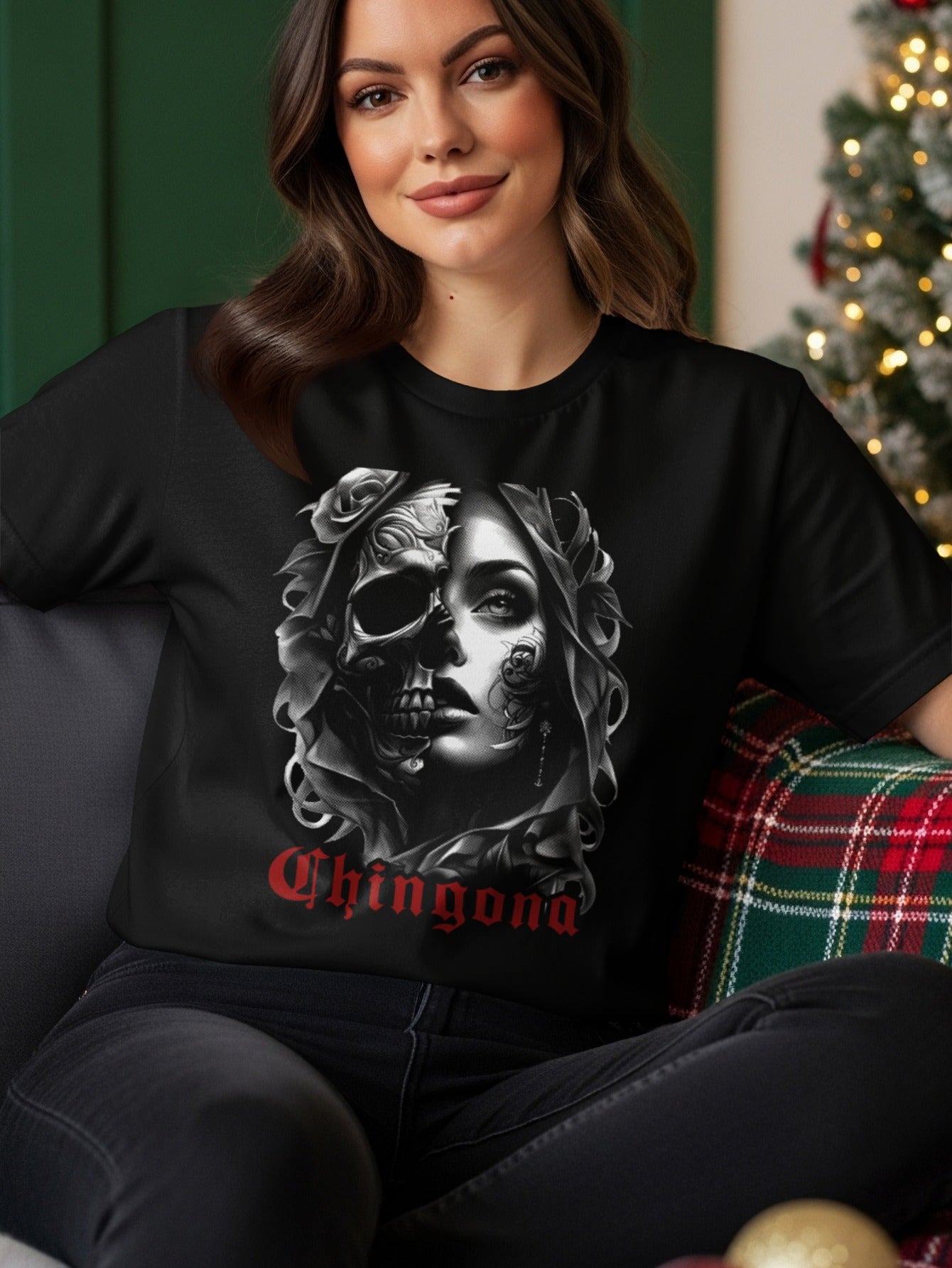 Woman wearing a black t-shirt with a skull and rose graphic and the word "Chingona".