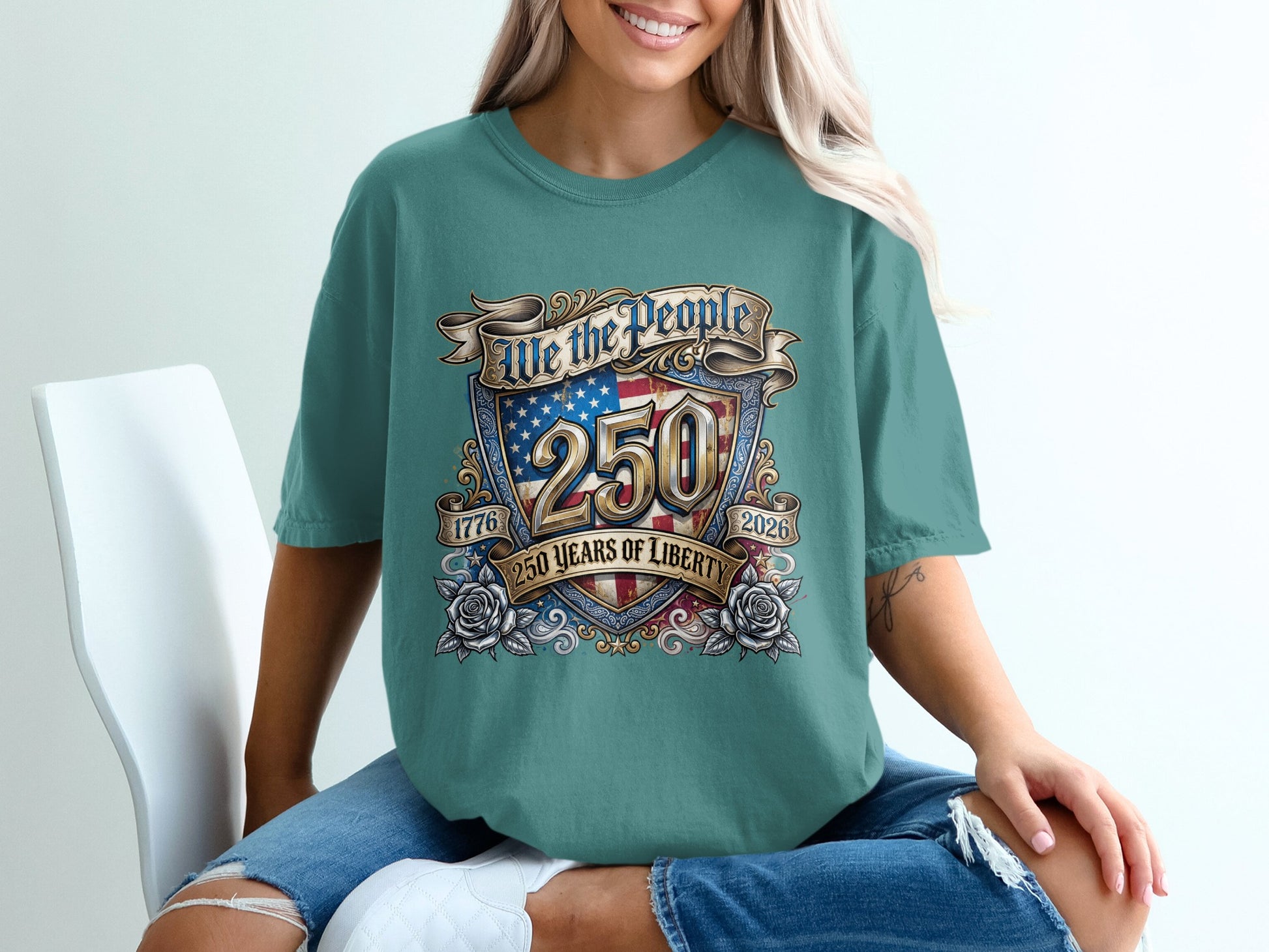 Teal t-shirt with "We the People 250 Years of Liberty 1776-2026" graphic.