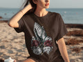 Brown t-shirt with praying hands, rosary, roses, cross, and 