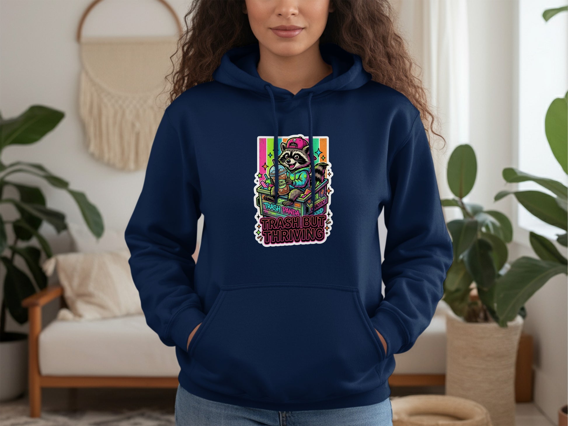 Navy hoodie with raccoon graphic and text "TRASH BUT THRIVING".
