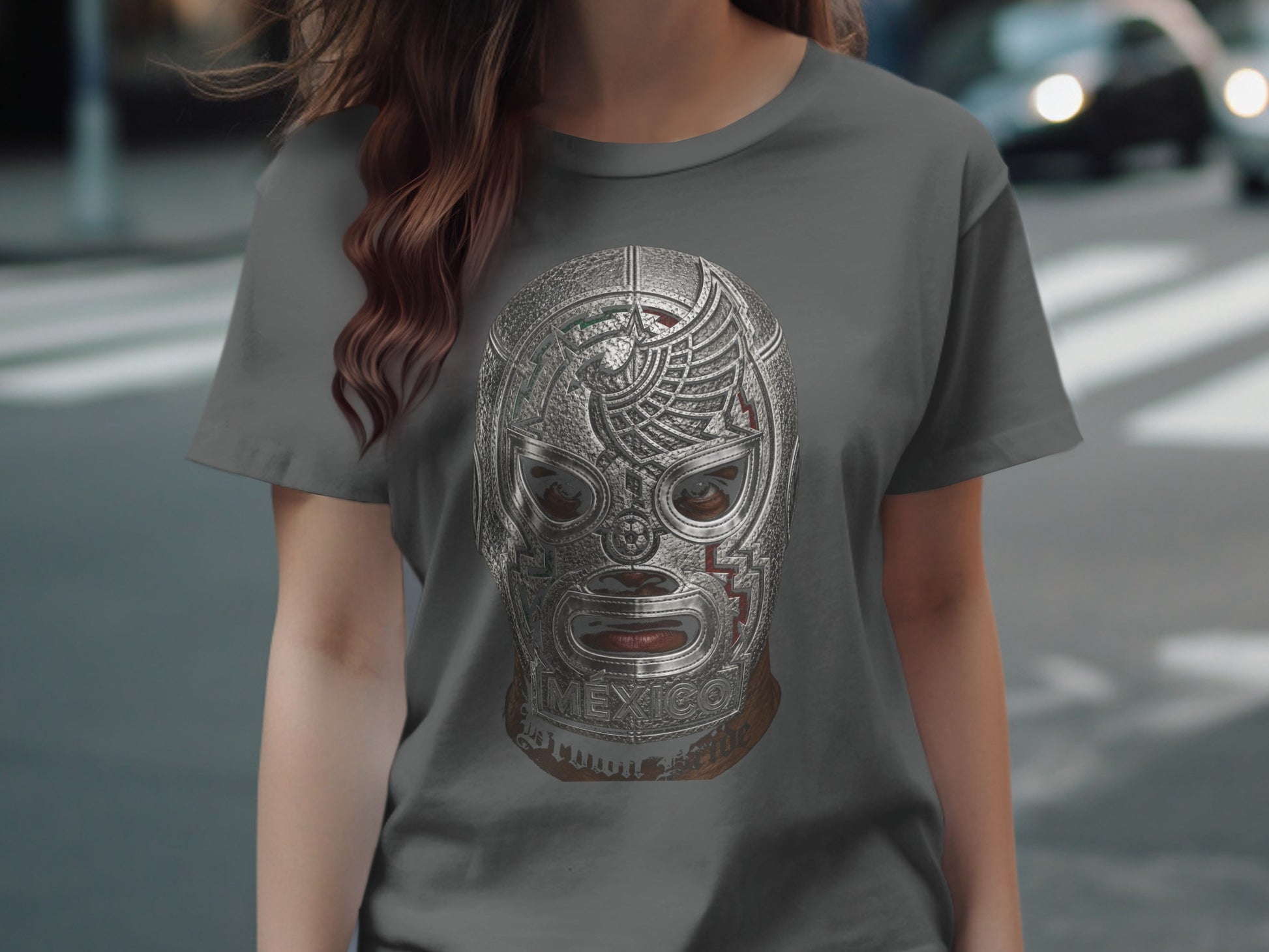Wrestler's mask with "MEXICO" text and metallic finish on a gray t-shirt.