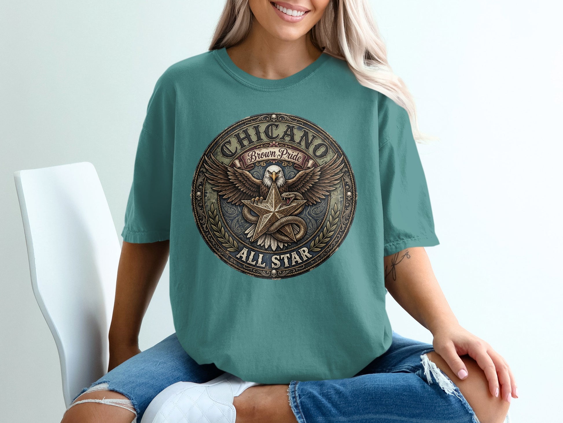 Teal t-shirt with "Chicano Brown Pride All Star" circular emblem featuring an eagle.