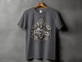 Gray t-shirt with a central graphic of a heart, cross, roses, and banner reading 