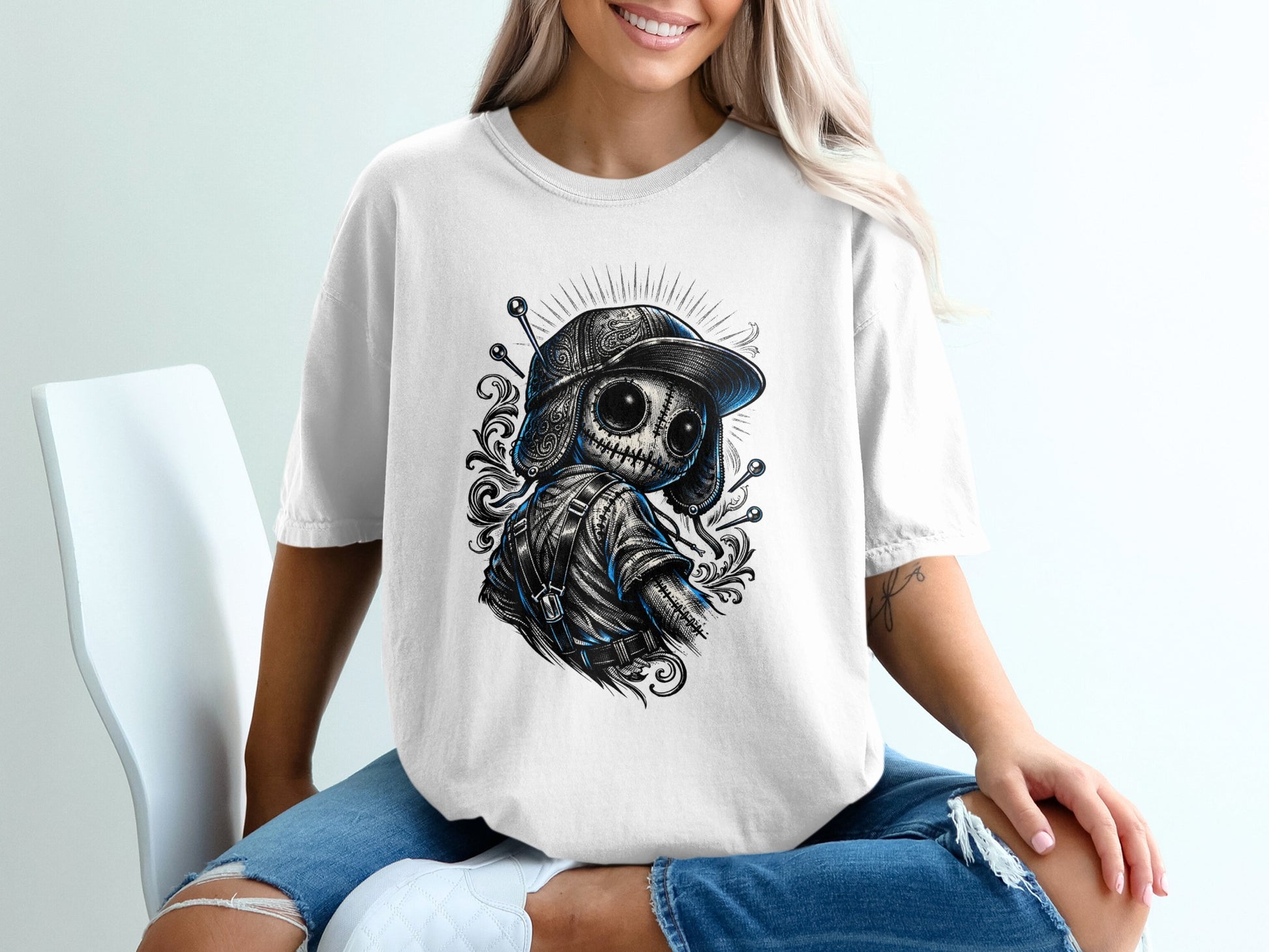 White t-shirt with skull character wearing a baseball cap.