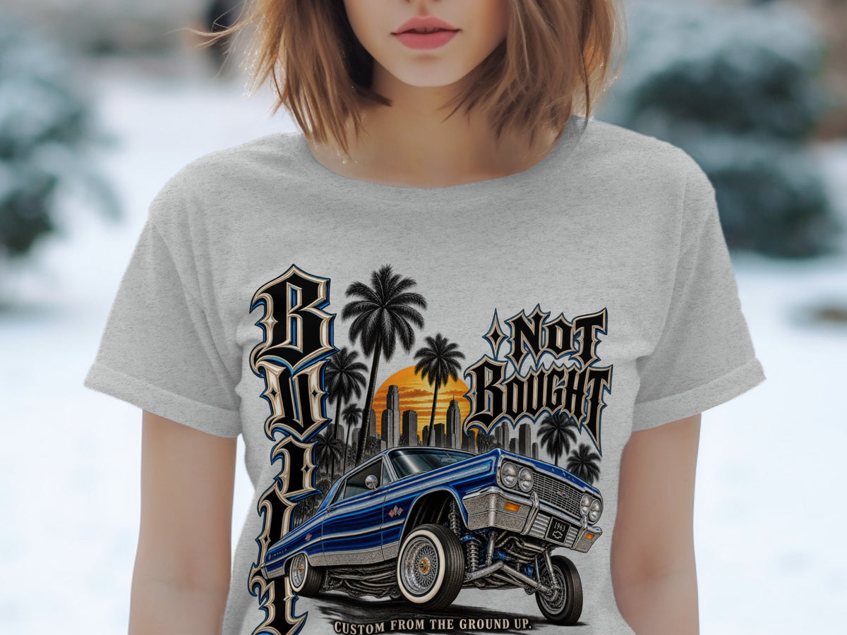 1963 Impala lowrider with city skyline, palm trees, and text "Not Bought".
