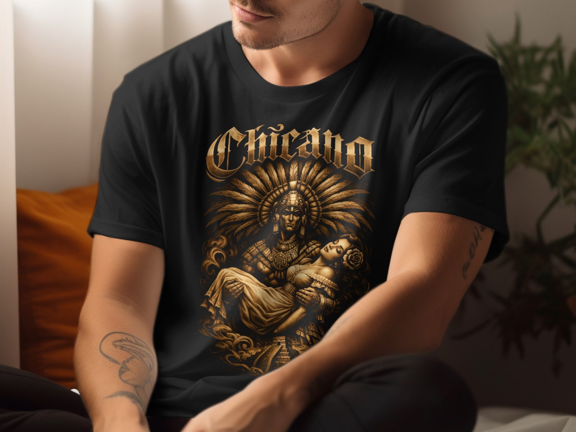 Black t-shirt with Chicano text above a golden Aztec warrior holding a woman.