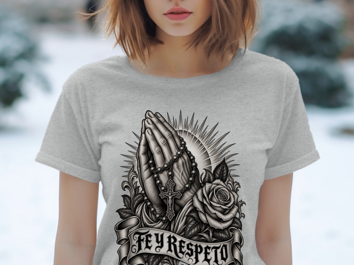 Grey t-shirt with a black and white graphic of praying hands, rosary, rose, and the words "Fey Respeto".