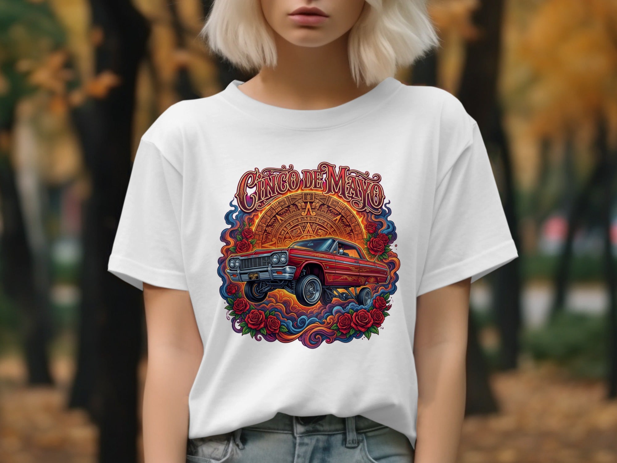 Red lowrider car surrounded by roses and Aztec calendar, Cinco de Mayo graphic.