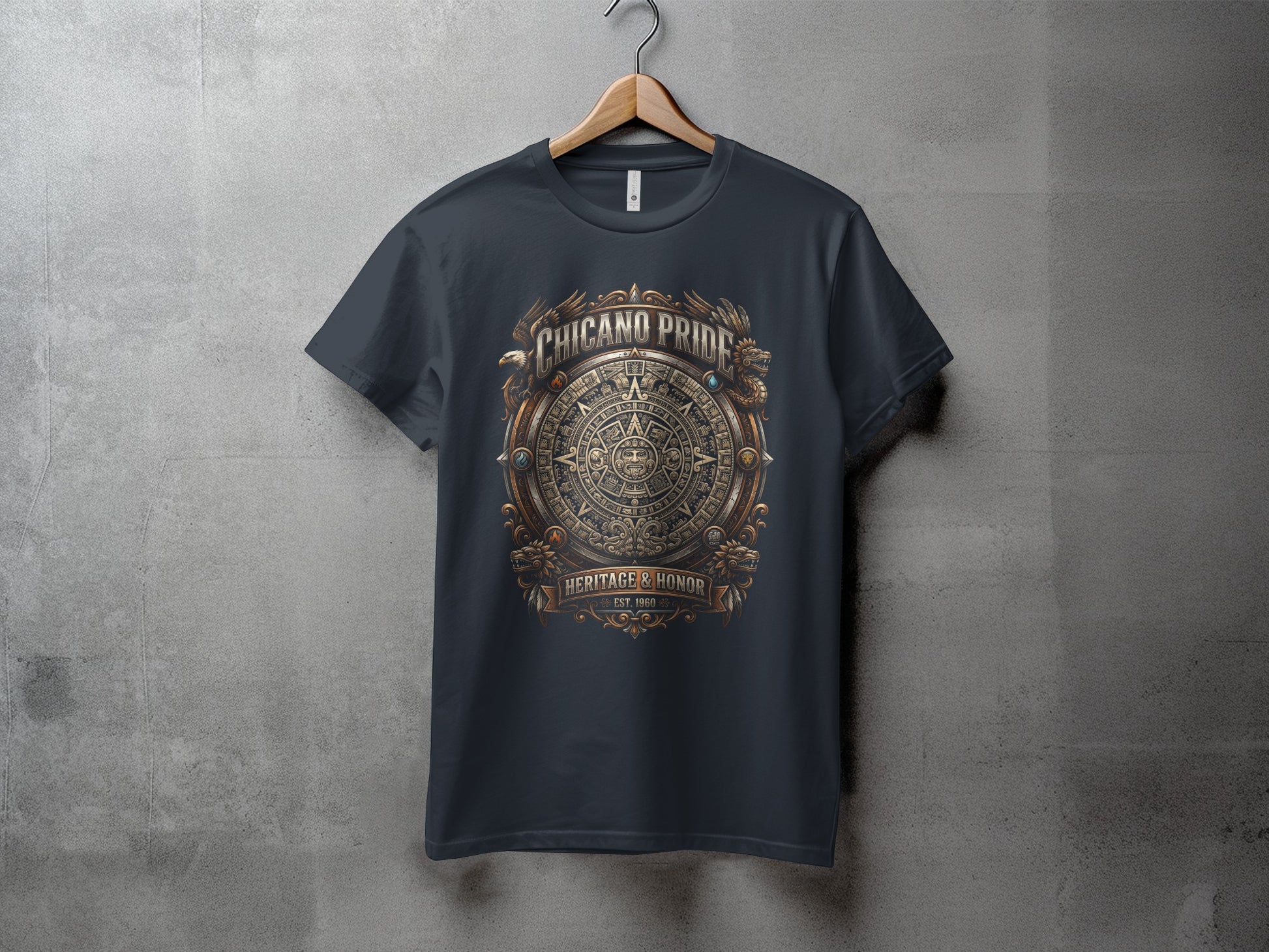 Dark t-shirt with ornate Aztec-inspired "Chicano Pride" graphic.