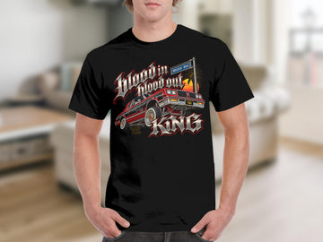 Black t-shirt with graphic of red classic car, sunset, and text.